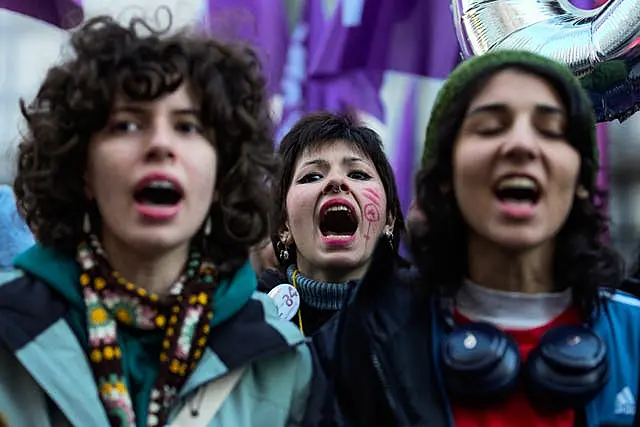 Women chant slogans during a rally marking the upcoming International Day for the Elimination of Violence Against Women,