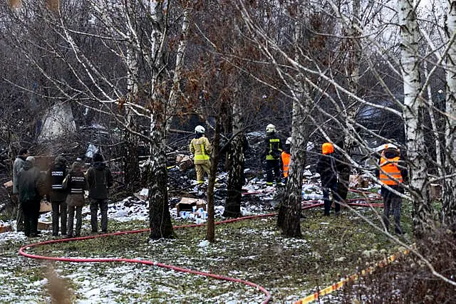 Lithuanian Emergency Ministry employees work at the site