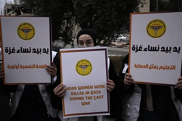 Members of the Palestinian Medical Relief Society mark the International Day for the Elimination of Violence Against Women in Bethlehem