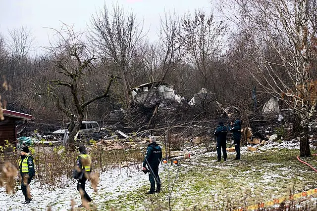 Workers at the site in a snowy forest scene