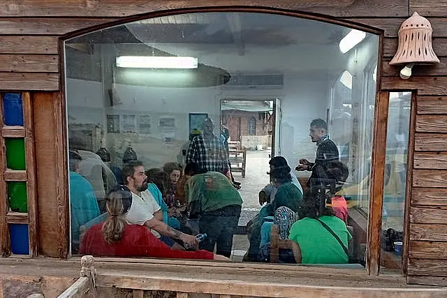 Survivors rest at a coffee shop in Marsa Alam