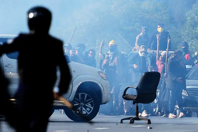 People throw stones towards police during clashes in Islamabad 