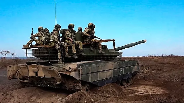 Russian servicemen ride a T-90M Proryv tank during combat training