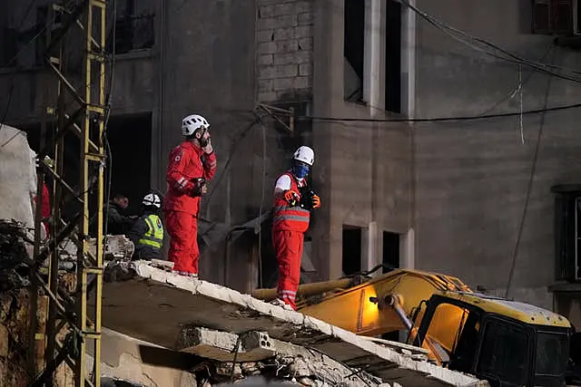 Rescuers search for victims at the site of an Israeli air strike in Beirut