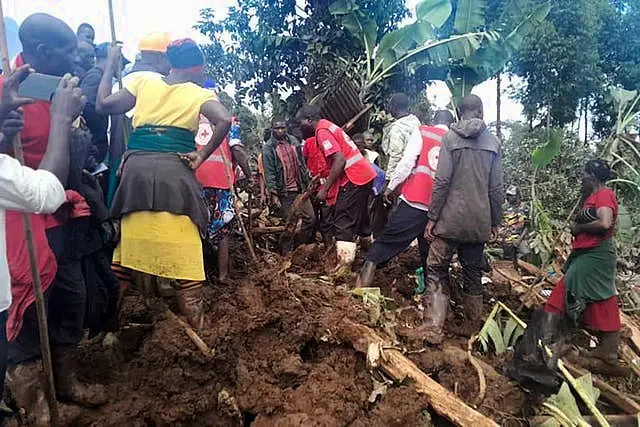 Rescuers search for bodies after a landslide