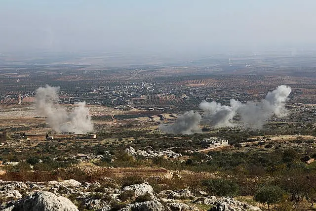 Smoke rises amid fighting between opposition factions and Syrian government troops