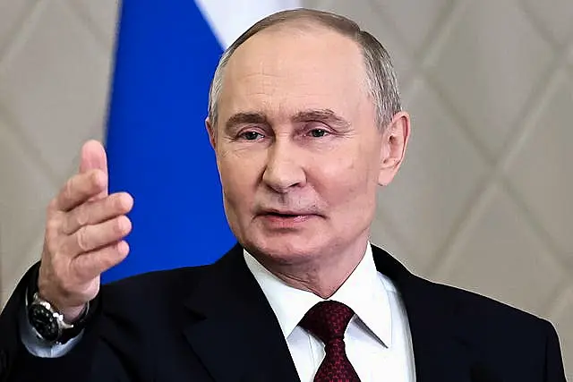 Russian President Vladimir Putin gestures while speaking to the media