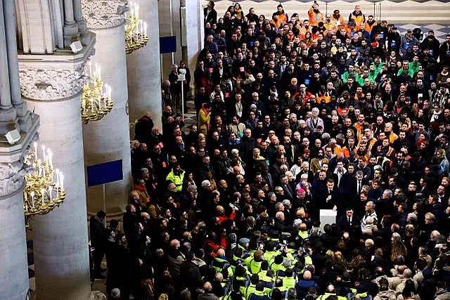 Crowds of construction workers inside the restored Notre Dame cathedral