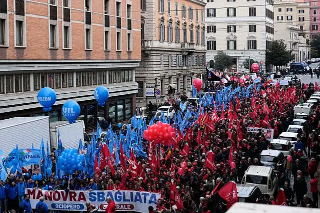 Demonstrators marching along streets in Rome