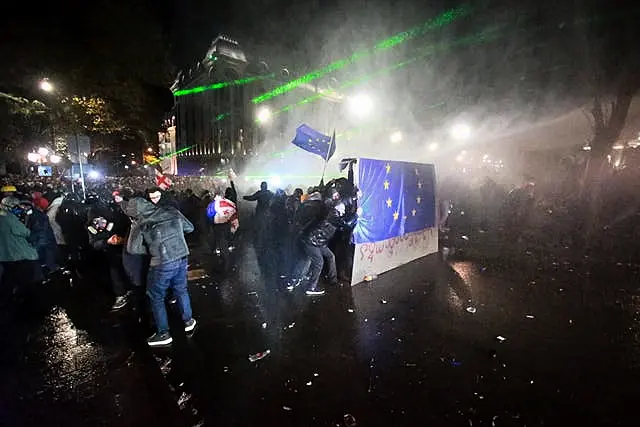 Protesters hold an EU flag during a rally outside the parliament building in Tbilisi, Georgia