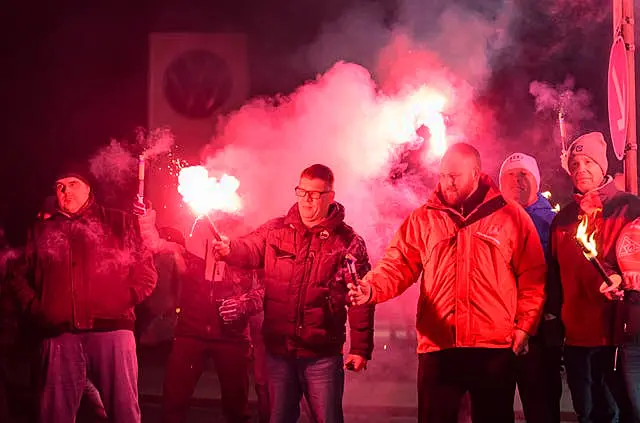 Volkswagen workers light up flares