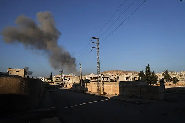 Smoke from an ai rstrike by government forces billows in the sky over the town of Khan Sheikhoun, south of Idlib