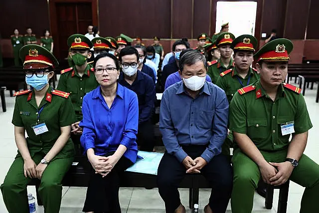 Truong My Lan, second left, attends trial in an appeal she filed against her death sentence in a financial fraud case in Ho Chi Minh City, Vietnam