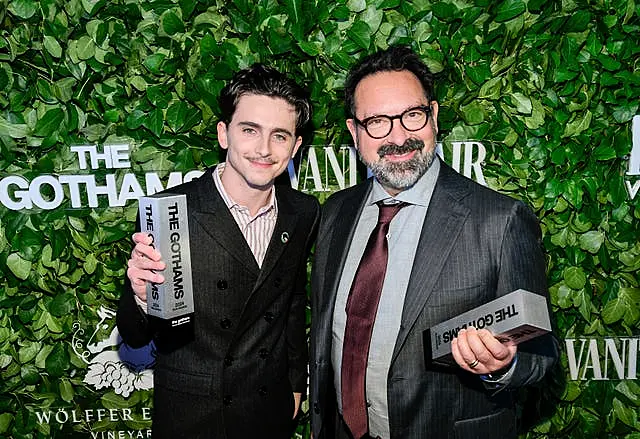 Timothee Chalamet, left, and James Mangold pose with the visionary tribute award for A Complete Unknown during The Gothams Film Awards