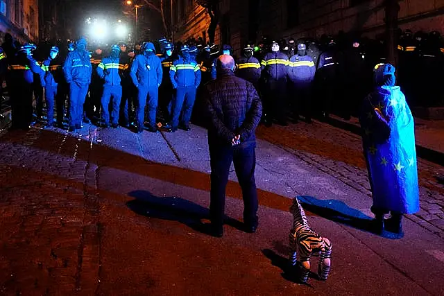 Police block demonstrators during a rally outside the parliament 