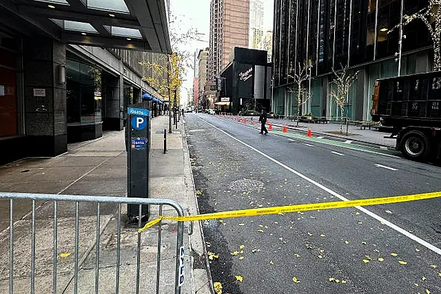 A New York police officer walks outside a hotel in midtown Manhattan