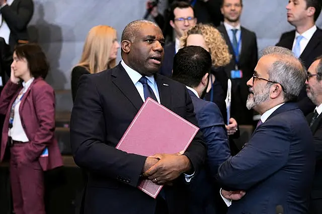 David Lammy with a folder of documents in his hand