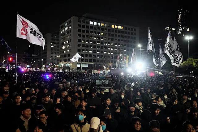 People gather in front of the National Assembly in Seoul