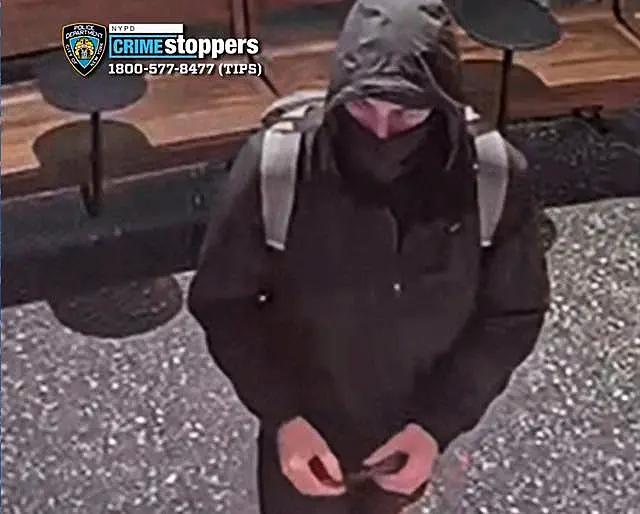 Grainy CCTV footage showing a man in a hoodie and mask