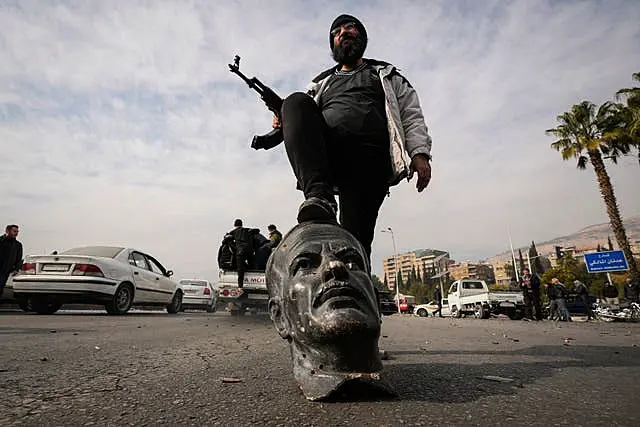 Man on foot of statue head