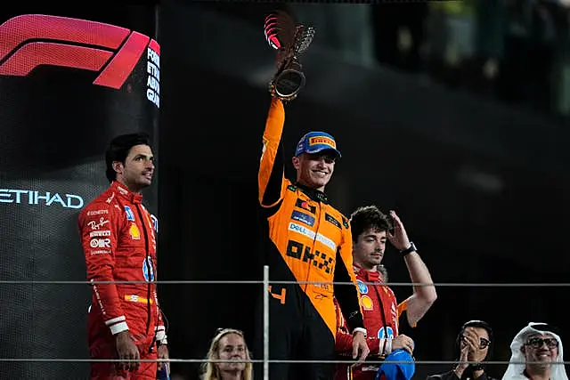 Lando Norris celebrates on the podium