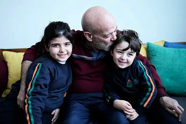 The freed man kisses his grandchildren