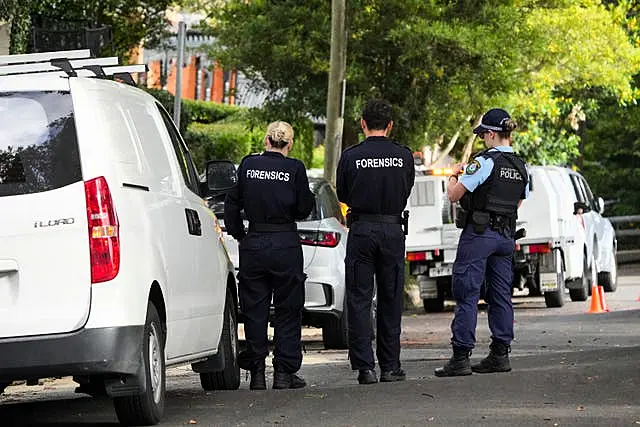 Police stand outside houses