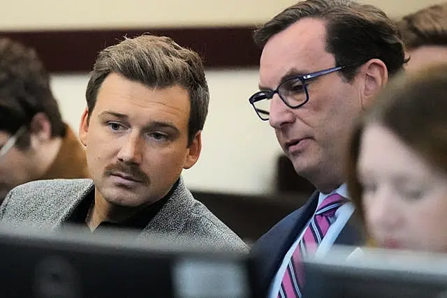 Morgan Wallen, left, speaks to his lawyer Worrick Robinson