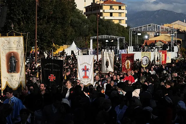 Members of catholic local brotherhoods arrive for Mass in Ajaccio 