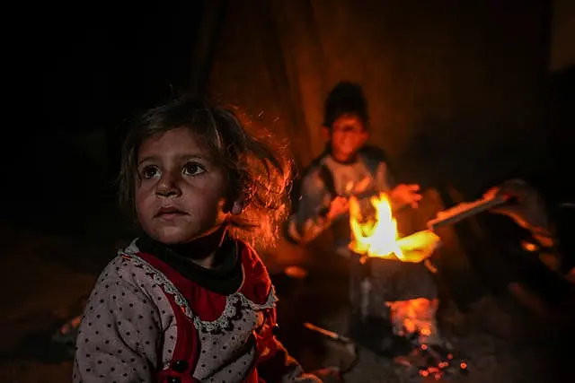 Young girl near a camp fire