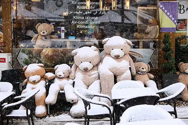 Teddy bears covered with snow outside a cafe in Sarajevo, Bosnia