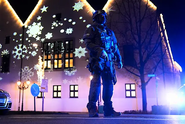 A police officer guards a cordoned-off area of the market in Magdeburg