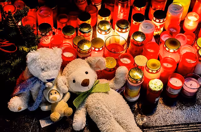Teddies and lit candles left in tribute