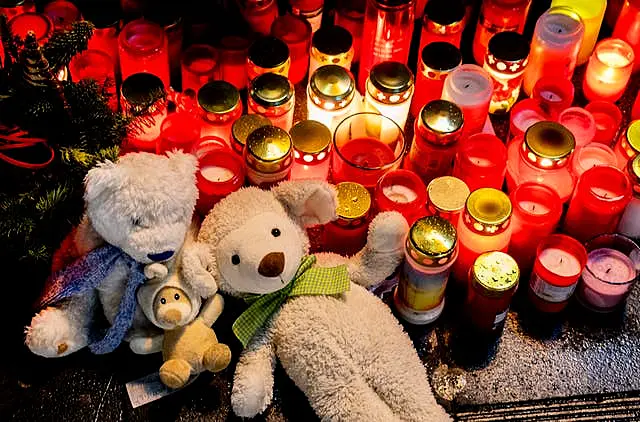 Teddies and lit candles left in tribute