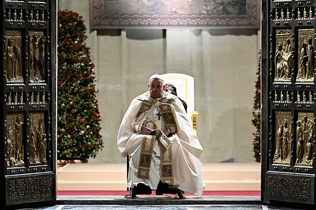 Pope Francis opens the holy door marking the start of the Catholic jubilar year 2025 before presiding over the Christmas Eve Mass in St Peter’s Basilica at the Vatican