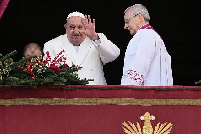 Pope Francis delivers the Christmas Day blessing from the main balcony of St Peter’s Basilica