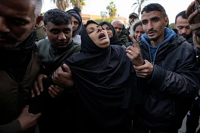 Mourners carry the bodies of five Palestinian journalists