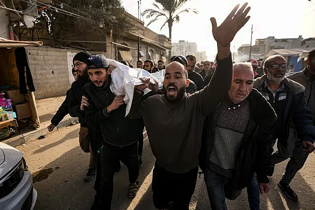 Mourners carry the bodies of five Palestinian journalists