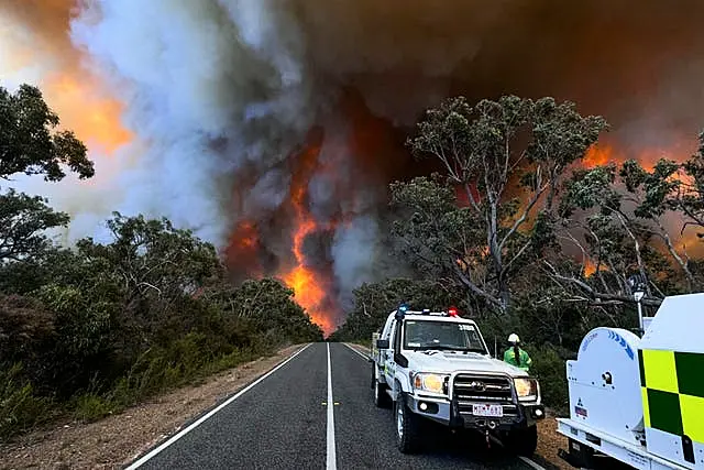 Fire crews watch as smoke billows from an out-of-control bushfire in the Grampians National Park