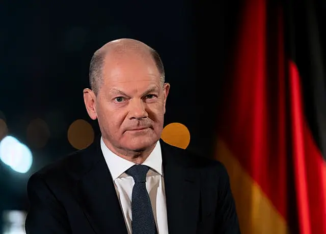 Olaf Scholz sits before the Reichstag