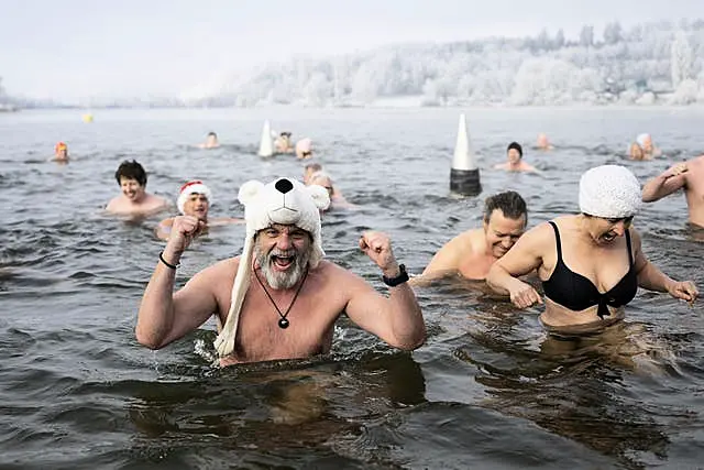 Swimmers attend the traditional New Year’s Eve swimming at lake Moossee in Moosseedorf, Switzerland