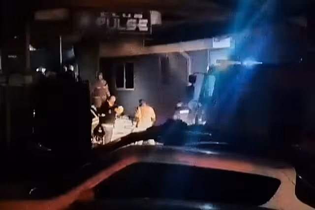 Rescue workers outside burnt-out building