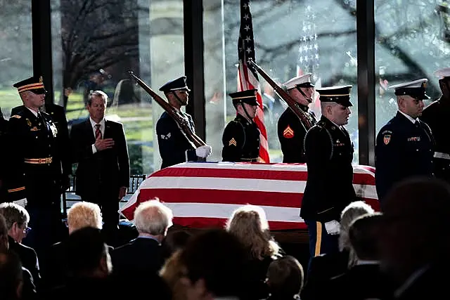 A military body bearer team places the flag-draped coffin of former US president Jimmy Carter on to the catafalque at the Jimmy Carter Presidential Library and Museum in Atlanta 