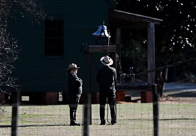 Karen Barry, left, and Randy Dillard ring the farm bell 