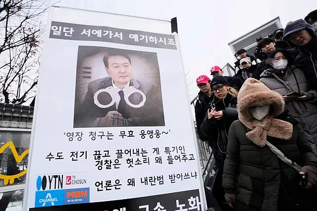 South Korean protesters with a sign