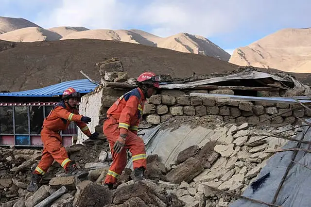 In this photo released by Xinhua News Agency, rescue workers conduct search and rescue for survivors in the aftermath of an earthquake in Changsuo Township of Dingri in Xigaze