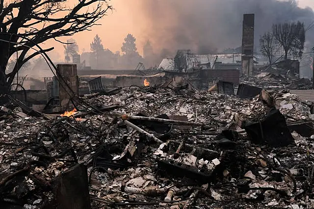 The Palisades Fire ravages a neighborhood amid high winds in the Pacific Palisades neighborhood of Los Angeles