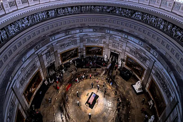 The flag-draped casket of former President Jimmy Carter lies in state at the rotunda of the US Capitol