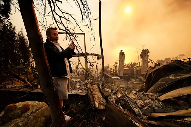 Kelly Kline looks out at his home damaged by the Palisades fire in Malibu 