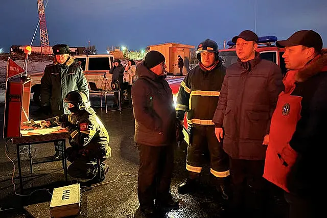 Governor of the Saratov region Roman Busargin, second right, speaks to firefighters